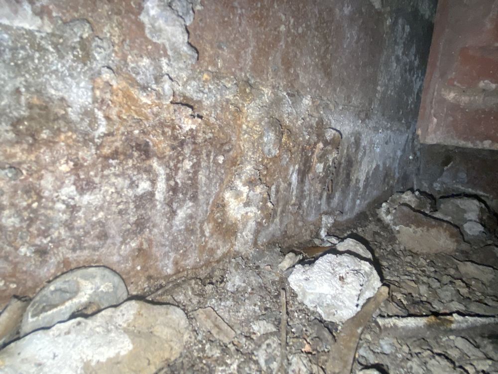 Water staining and calcite on the foundation walls from moisture ingress, found during a defect investigation inspection in Winston Hills