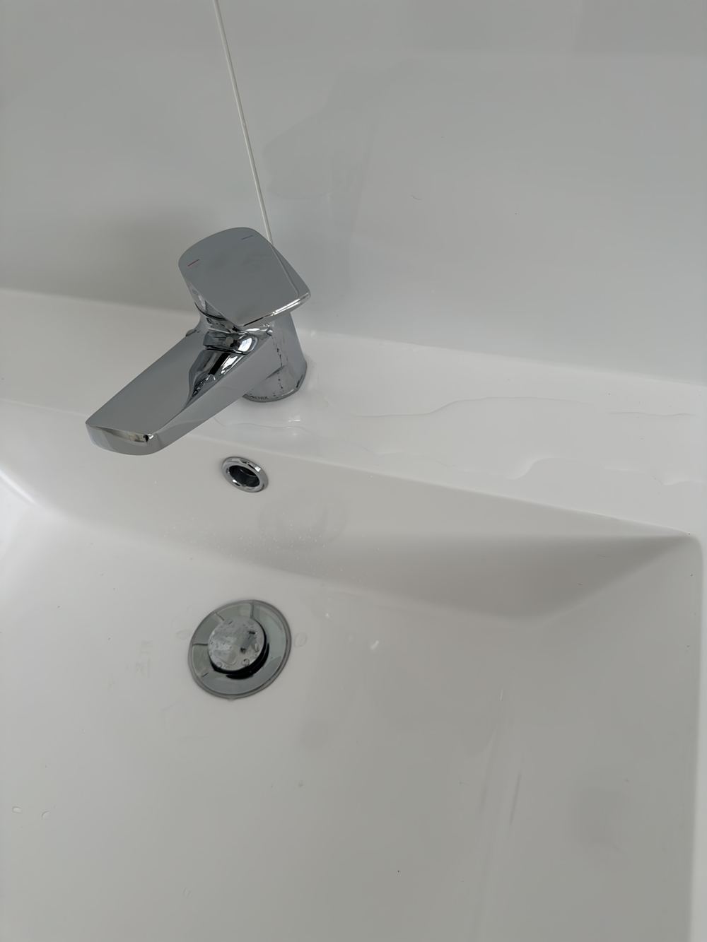 Bathroom mixer leaking at handover, needing a plumber before it damages the vanity, found during a handover inspection in Rouse Hill