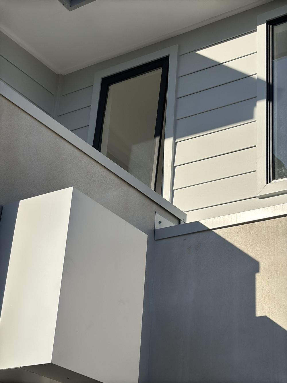 No pressure flashing holding the roof upturn at the parapet wall, found during a handover inspection in Rouse Hill