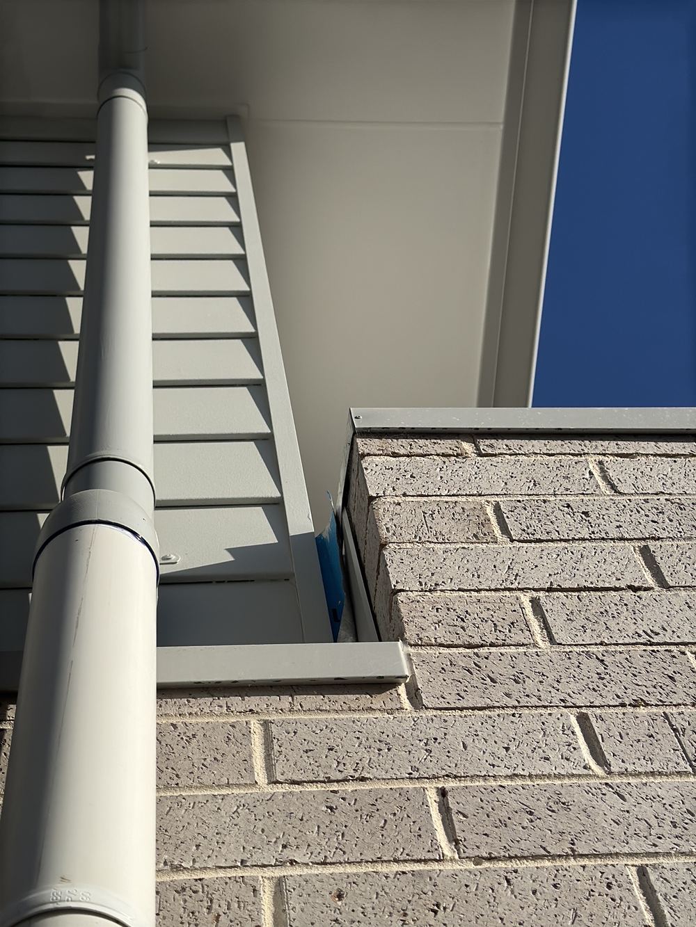 Roof penetration flashing badly installed, needing refitting to stay watertight, found during a handover inspection in Rouse Hill