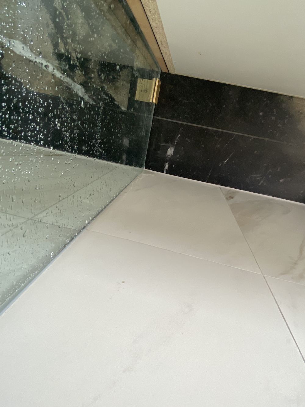 Water escaping under the shower screen onto the bathroom floor, found during a handover inspection in Rouse Hill